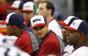 Andre Rienzo sits in the dugout unaware his teammates placed a cup with bubble gum on his cap (Photo)