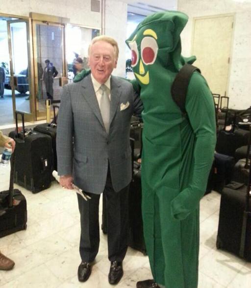 Vin Scully poses with Yasiel Puig dressed as Gumby