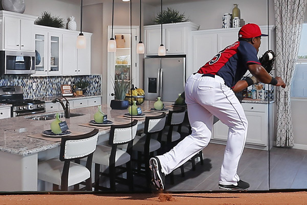 Indians outfielder Carlos Moncrief makes a catch in front of a picture of a kitchen on the outfield wall (Pic)