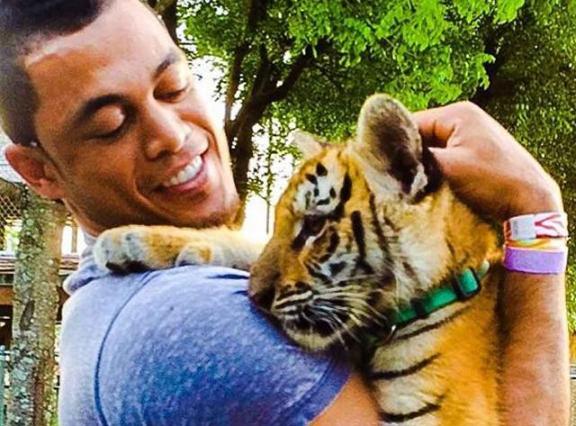 Giancarlo Stanton takes a break from hitting homers to cuddle with adorable tiger cub
