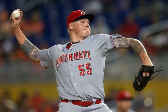 Reds' Latos gets 1st win against hometown Marlins