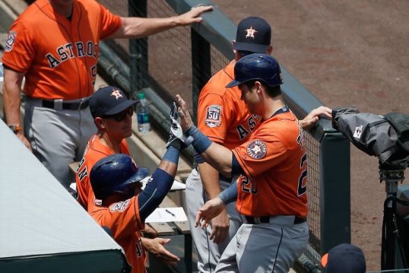 Tucker helps Astros to 8-4 win and sweep of Rockies
