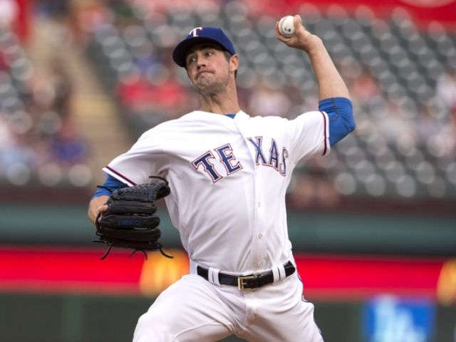 Hamels makes it 10 straight wins as Rangers top Astros 2-1