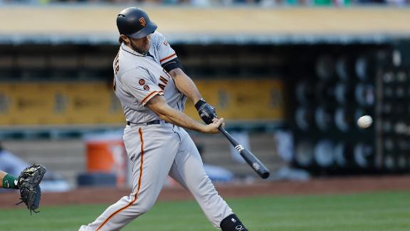 Bumgarner pitches Giants to win and swings the bat, too